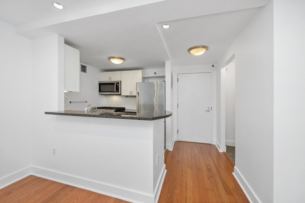 42 8th Street, Unit 1315 Boston, MA 02129 - Photo 3 of 20 a kitchen with a refrigerator and a stove top oven