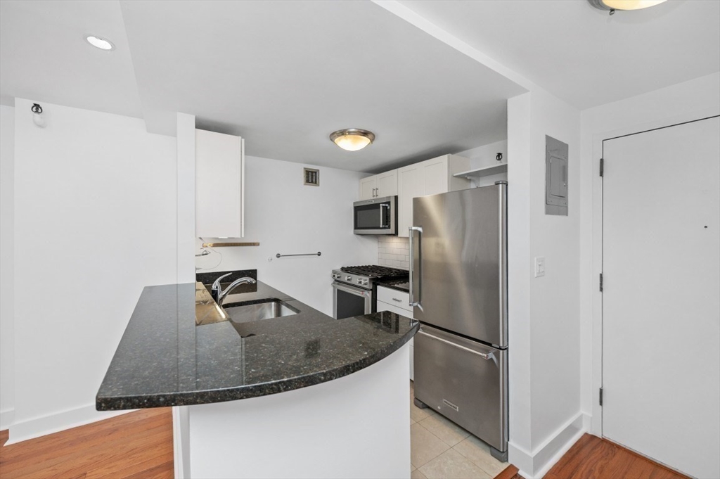 42 8th Street, Unit 1315 Boston, MA 02129 - Photo 4 of 20 a kitchen with stainless steel appliances granite countertop a refrigerator a sink and a stove