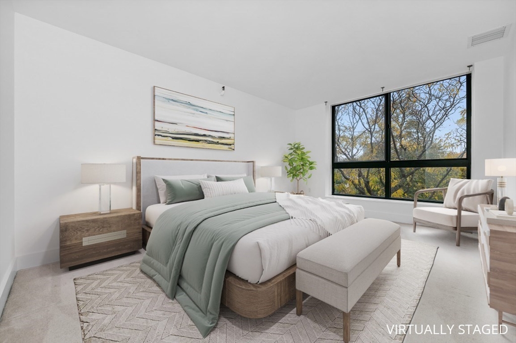 42 8th Street, Unit 1315 Boston, MA 02129 - Photo 6 of 20 a bedroom with a bed and a large window