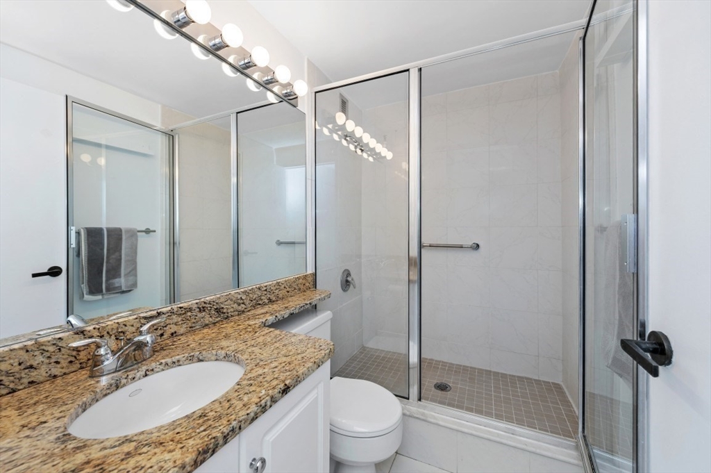 42 8th Street, Unit 1315 Boston, MA 02129 - Photo 7 of 20 a bathroom with a granite countertop sink toilet and shower