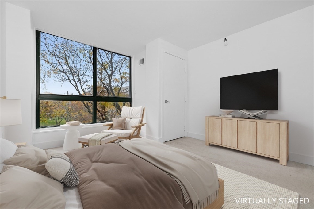 42 8th Street, Unit 1315 Boston, MA 02129 - Photo 8 of 20 a bedroom with bed and a flat screen tv