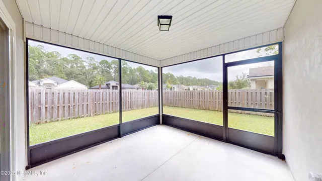 a view of an empty room with windows