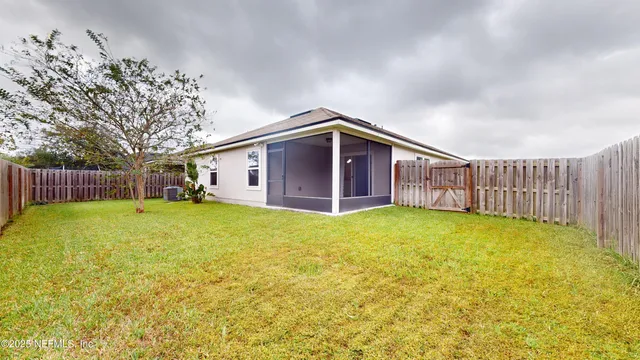 a view of a house with a backyard