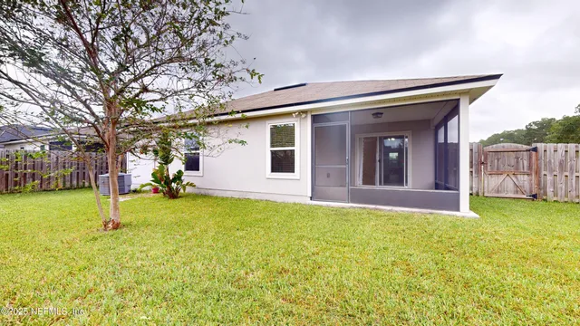 a view of a house with a backyard