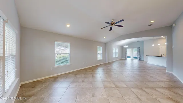 a view of a livingroom with a ceiling fan and window