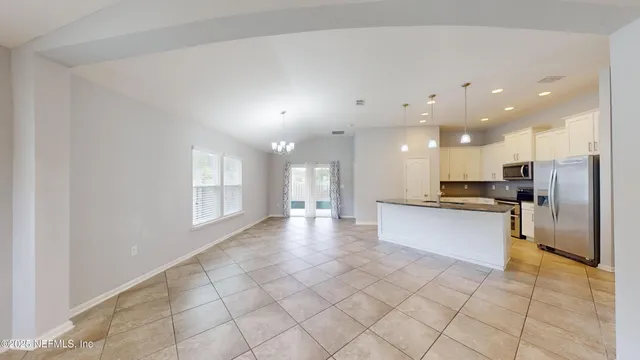 a view of a kitchen with a sink and microwave
