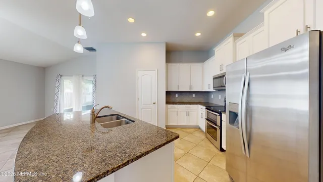 a kitchen with kitchen island sink refrigerator and stove