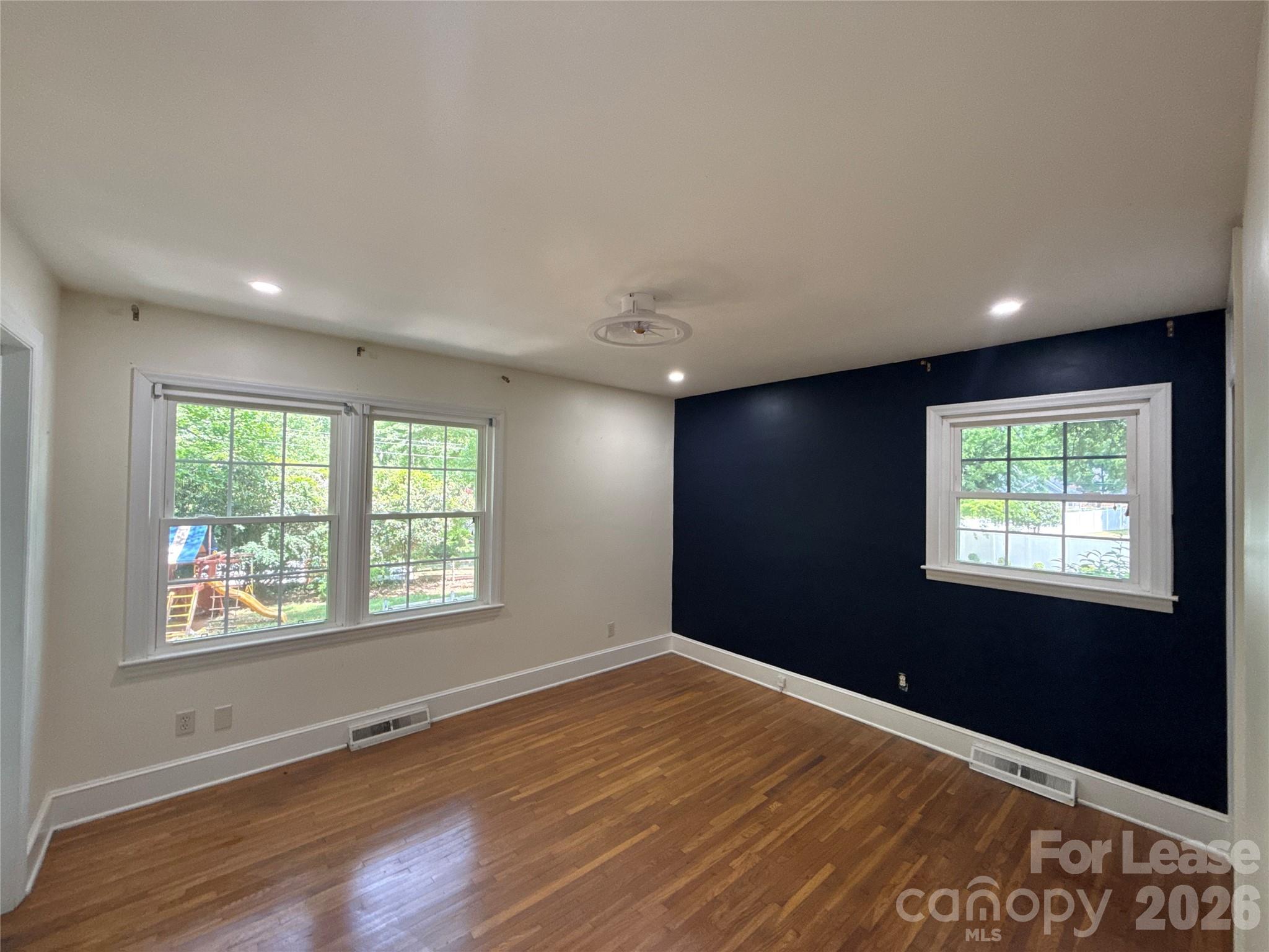 3927 Sharon View Road Charlotte, NC 28226 - Photo 12 of 14 a view of an empty room with wooden floor and a window