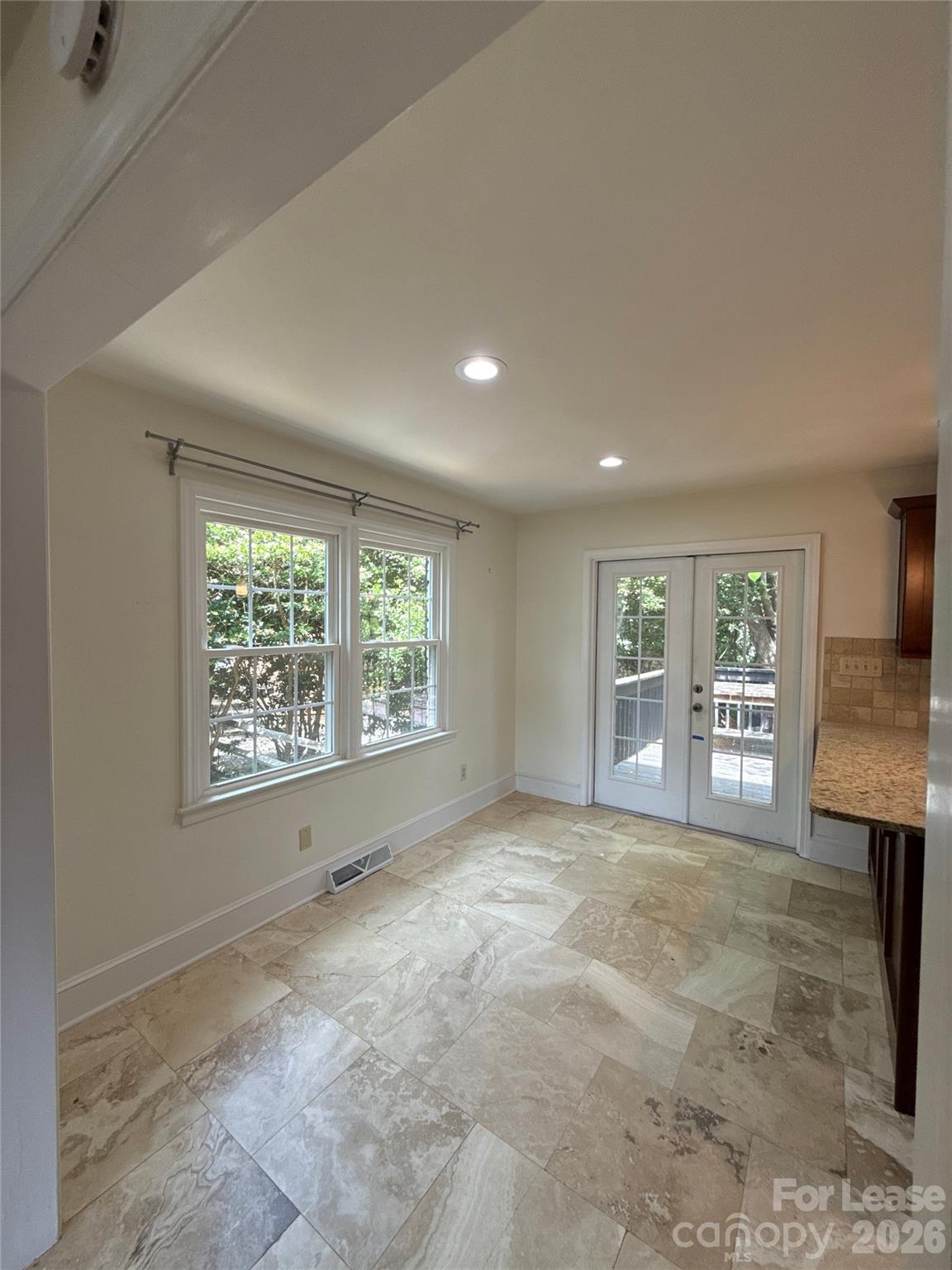 3927 Sharon View Road Charlotte, NC 28226 - Photo 3 of 14 a view of an empty room with a window and a kitchen