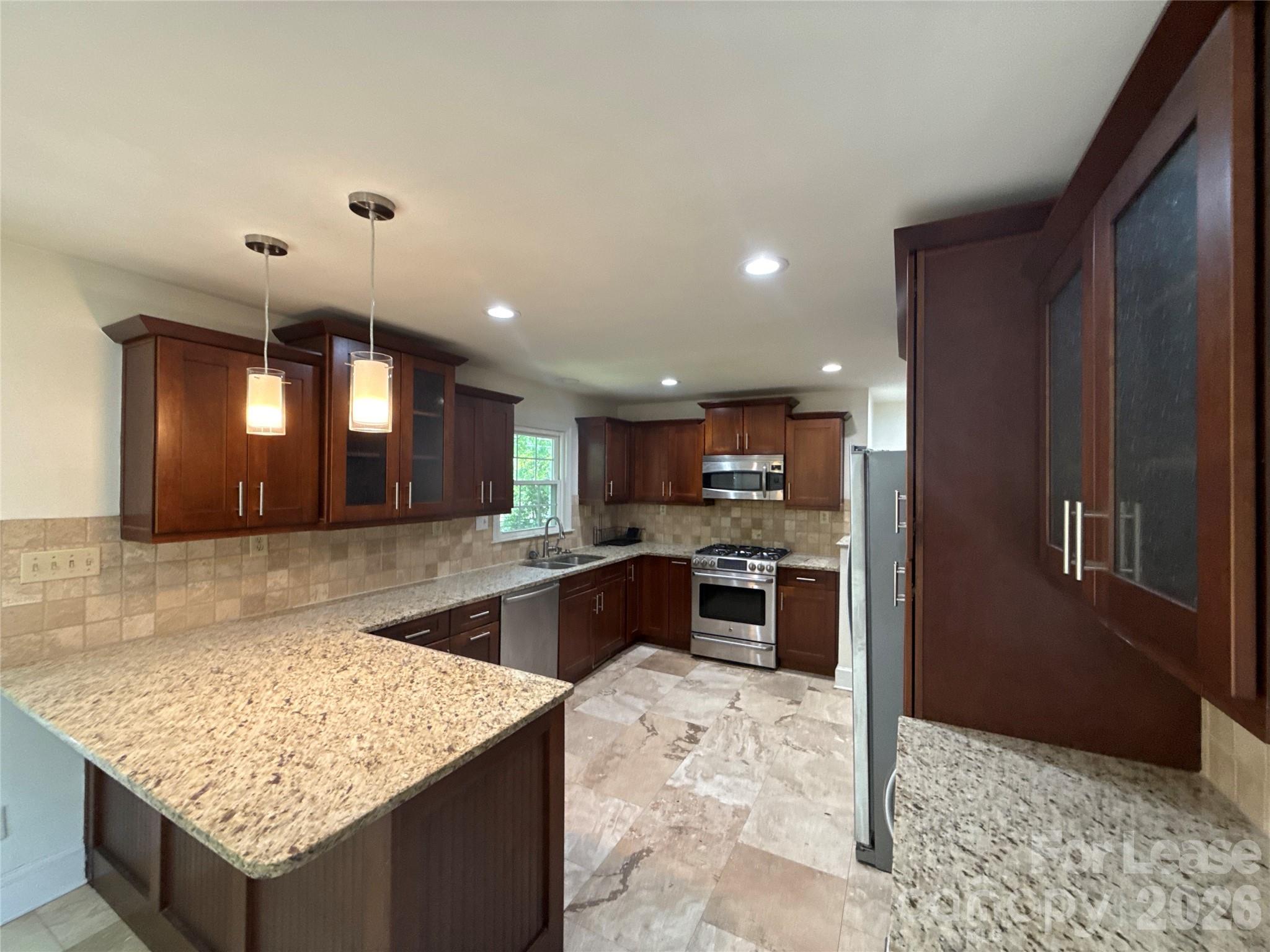 3927 Sharon View Road Charlotte, NC 28226 - Photo 4 of 14 a kitchen with stainless steel appliances granite countertop granite counter tops and a refrigerator