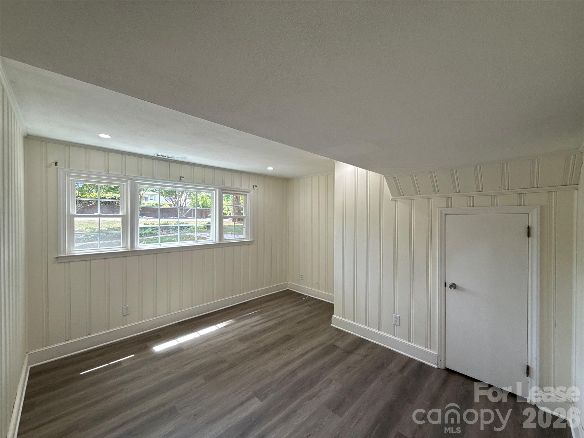 3927 Sharon View Road Charlotte, NC 28226 - Photo 8 of 14 an empty room with wooden floor and windows