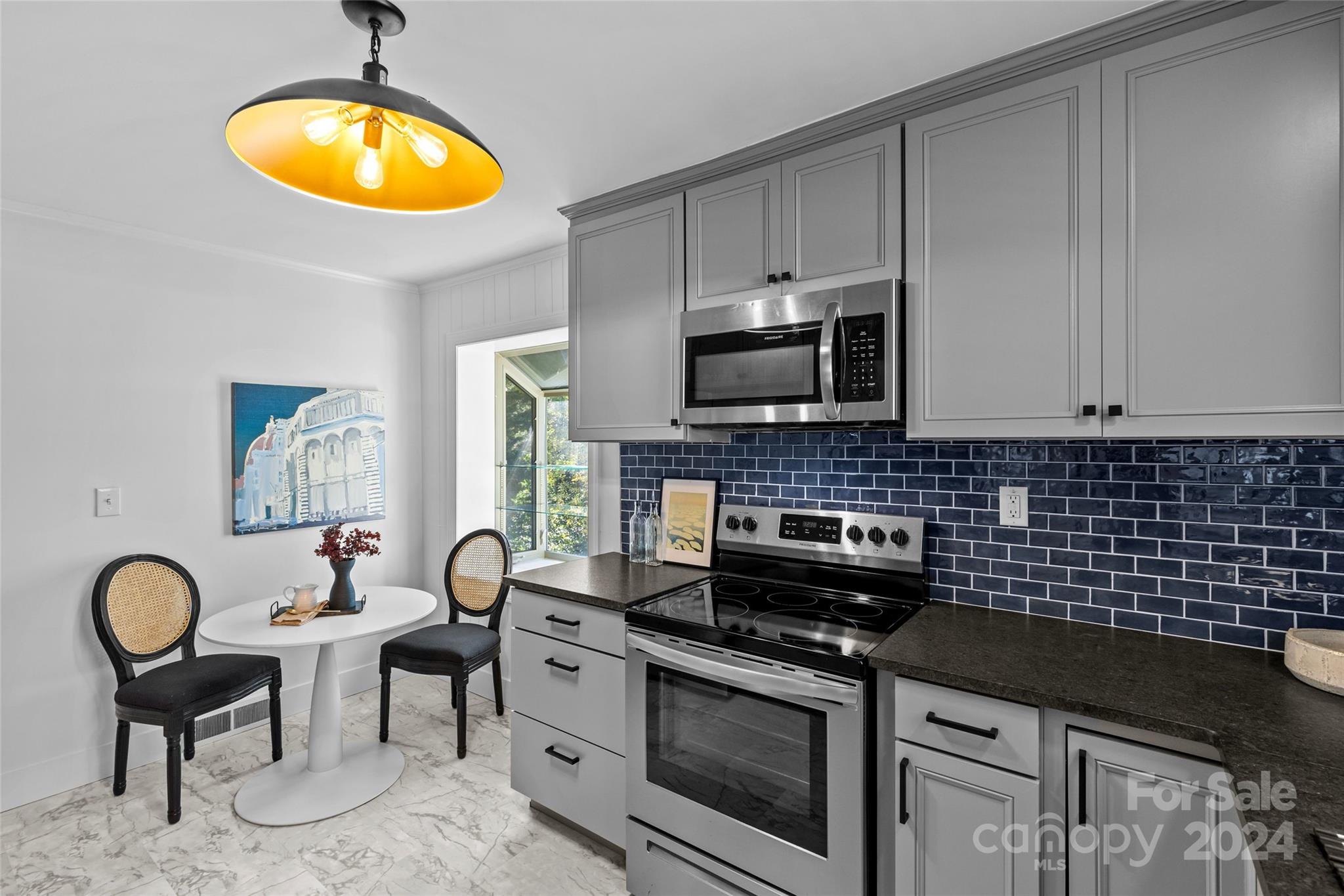 1639 Merry Oaks Road Charlotte, NC 28205 - Photo 14 of 47 a kitchen with a stove a sink and a microwave