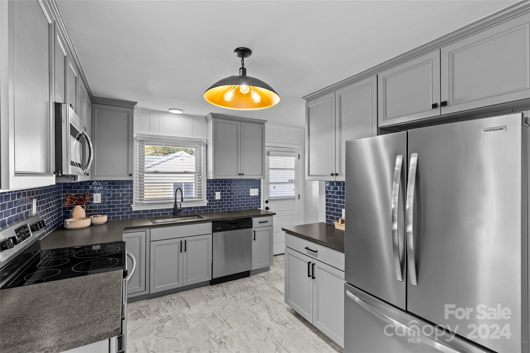 1639 Merry Oaks Road Charlotte, NC 28205 - Photo 15 of 47 a kitchen with stainless steel appliances granite countertop a refrigerator sink and stove