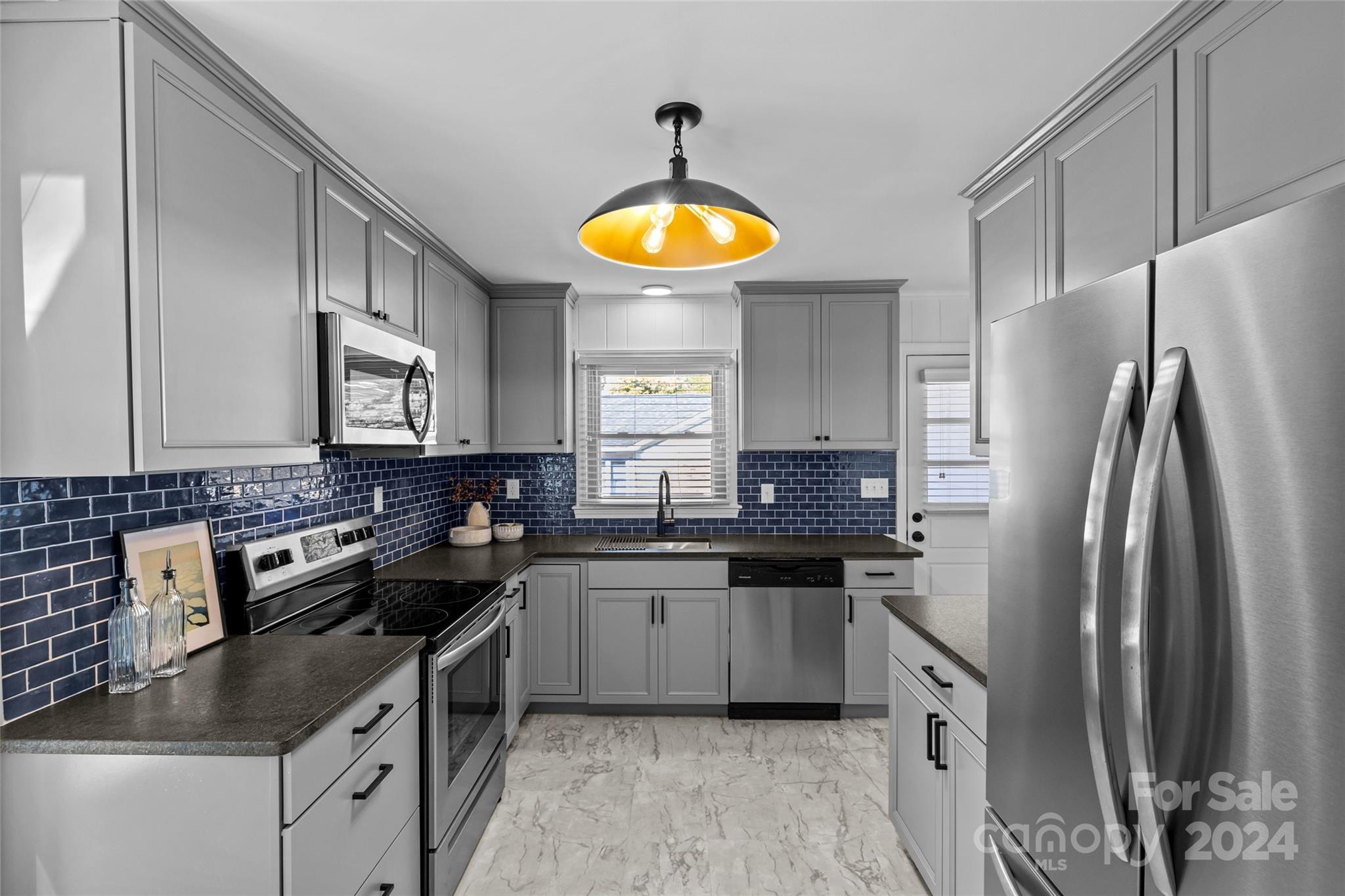 1639 Merry Oaks Road Charlotte, NC 28205 - Photo 16 of 47 a kitchen with stainless steel appliances granite countertop a sink stove refrigerator and cabinets