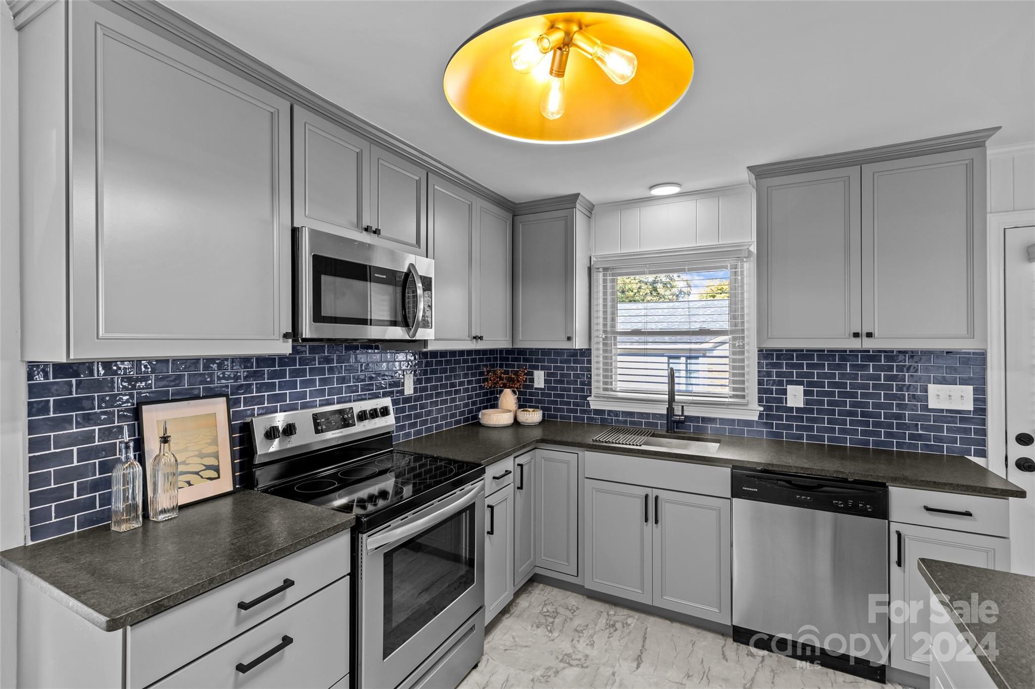 1639 Merry Oaks Road Charlotte, NC 28205 - Photo 18 of 47 a kitchen with granite countertop stainless steel appliances a stove a sink and a microwave