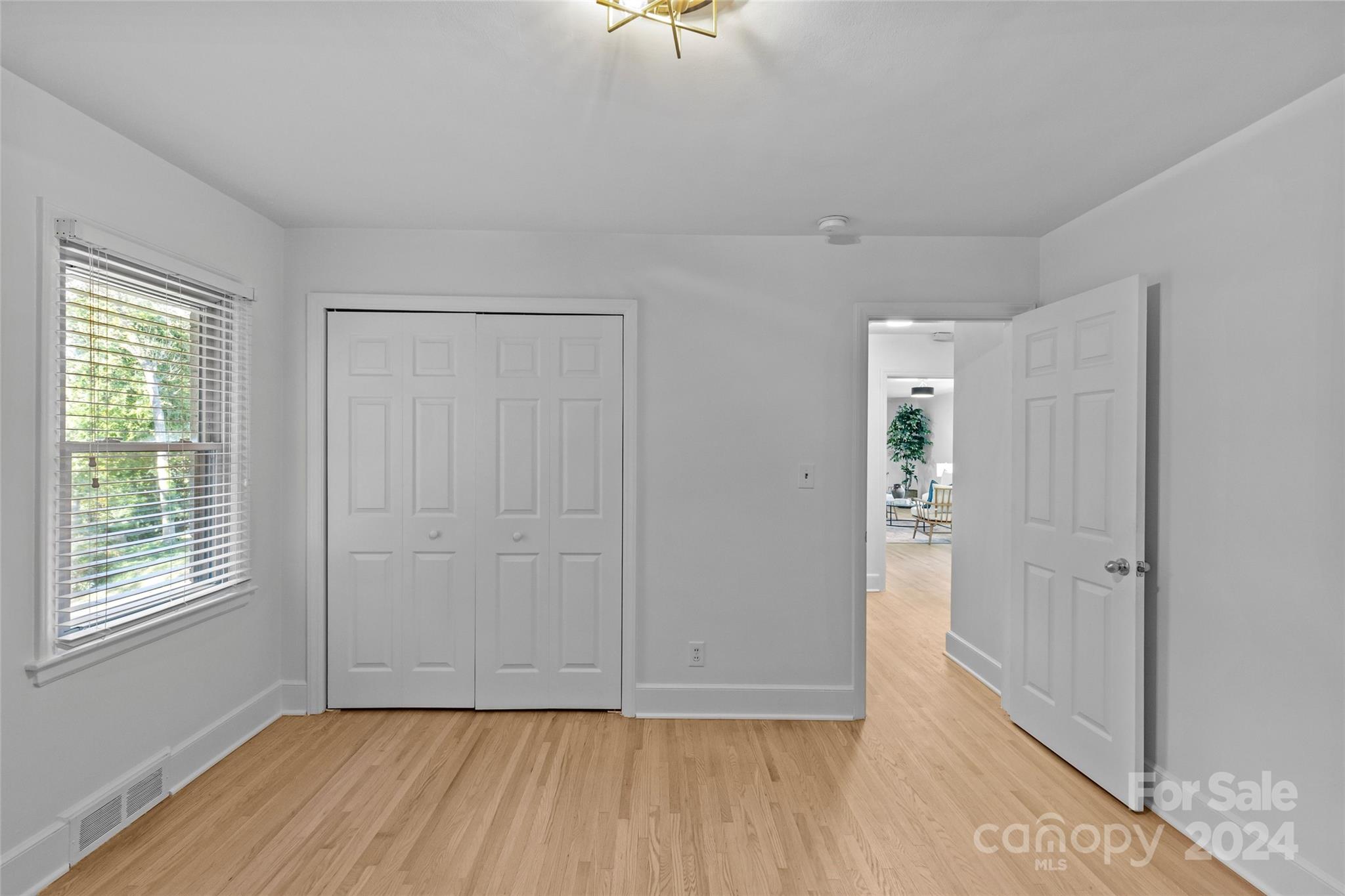 1639 Merry Oaks Road Charlotte, NC 28205 - Photo 28 of 47 a view of an empty room with a window and wooden floor