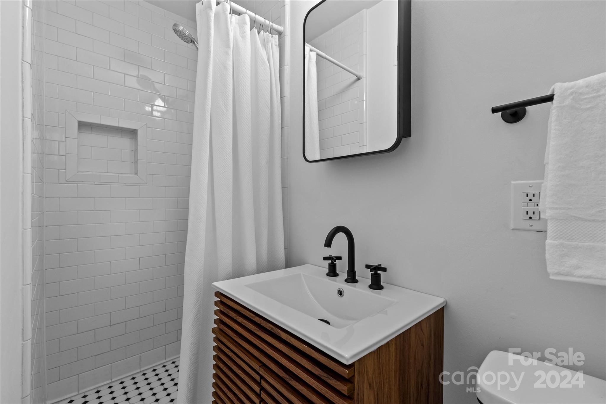 1639 Merry Oaks Road Charlotte, NC 28205 - Photo 33 of 47 a bathroom with a sink a toilet and mirror