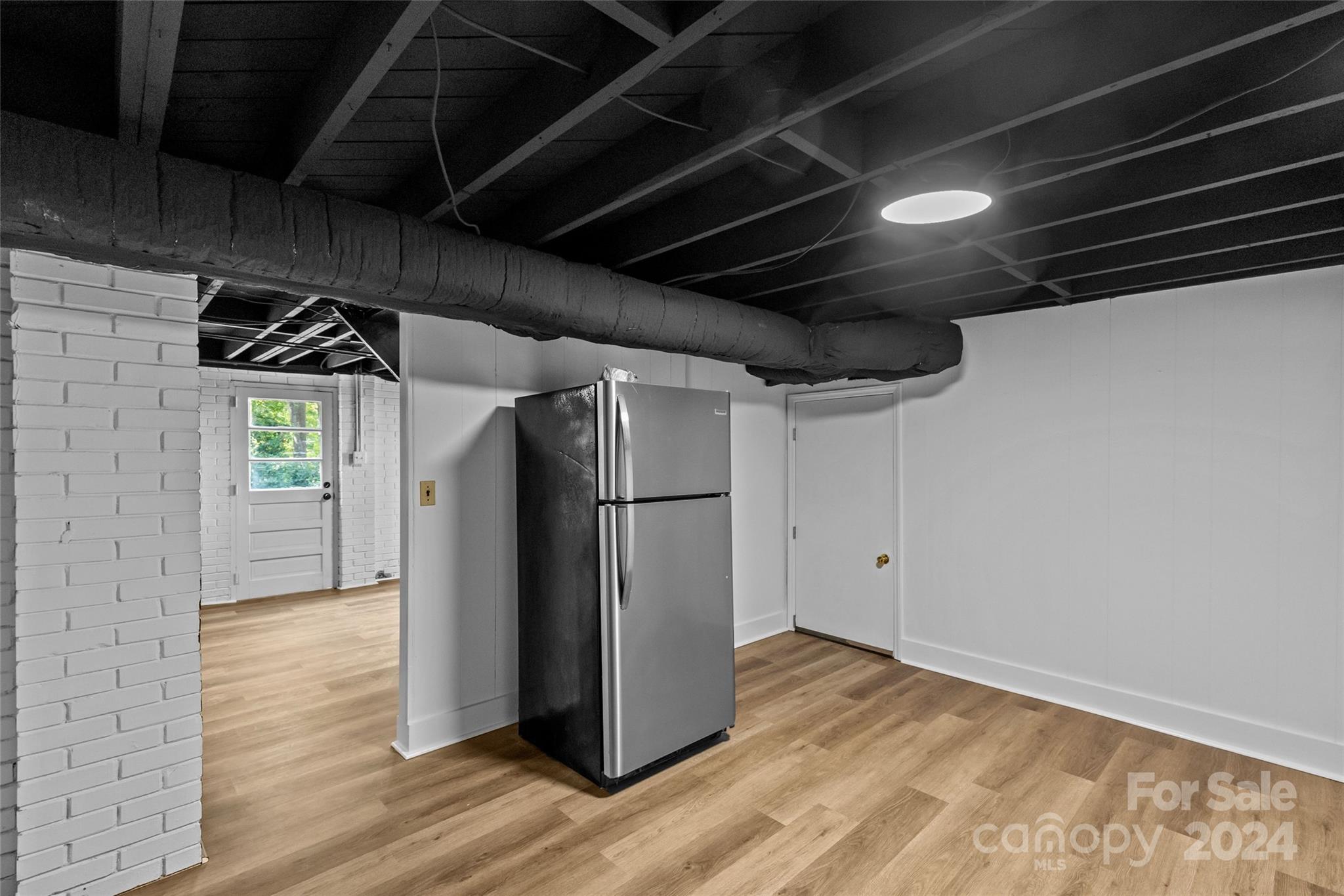 1639 Merry Oaks Road Charlotte, NC 28205 - Photo 36 of 47 a view of a refrigerator in kitchen and an empty room