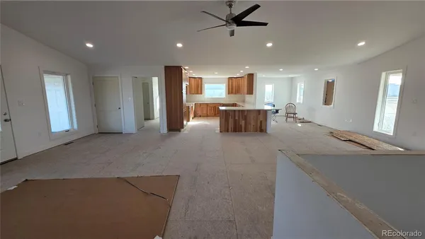 a view of a kitchen with a refrigerator and a ceiling fan