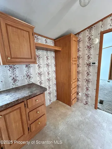 a bathroom with a granite countertop sink a mirror and shower