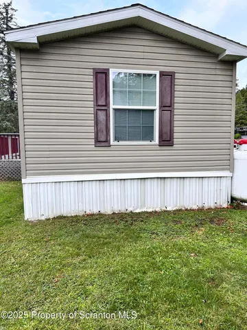 a view of a house with a yard and stairs