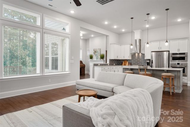a living room with furniture and kitchen view