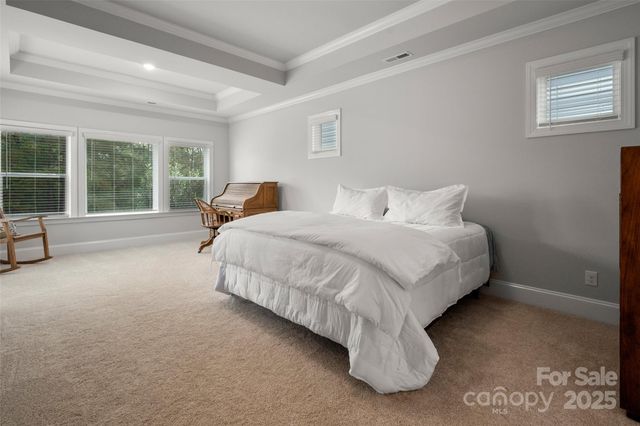 a spacious bedroom with a bed and window