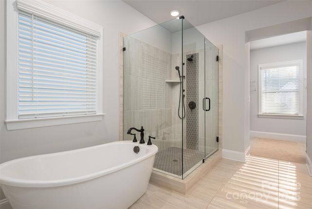 a white bath tub sitting next to a shower