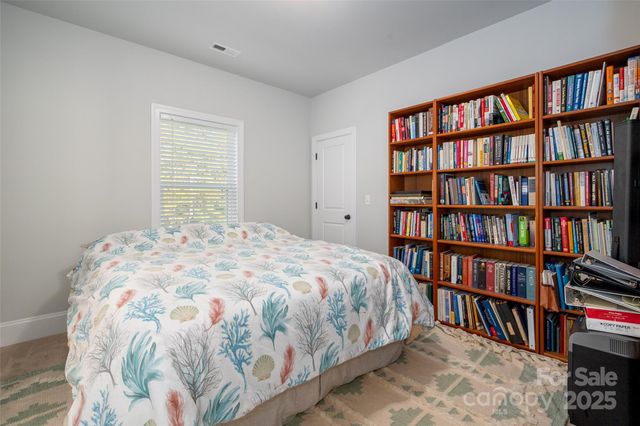 a bedroom with a bed and a book shelf