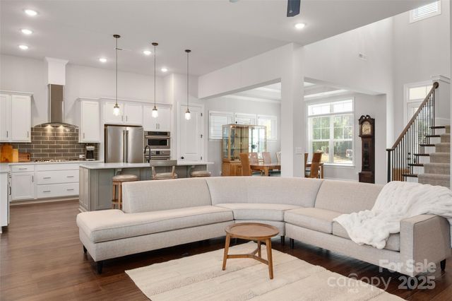 a living room with furniture and kitchen view