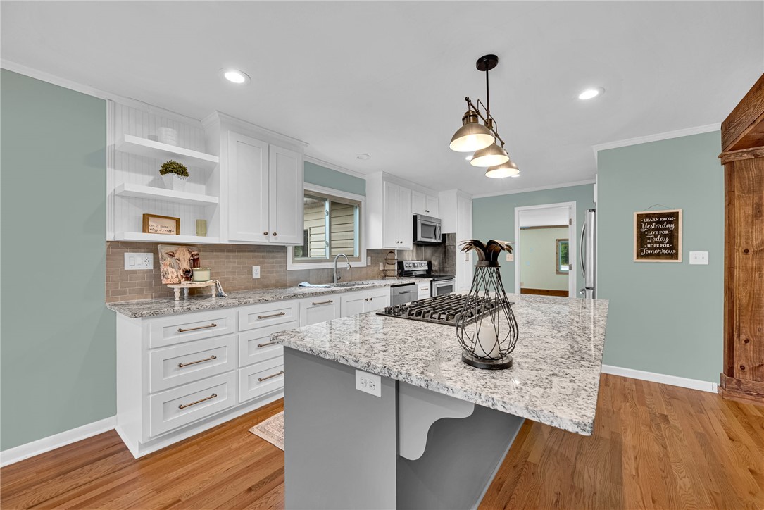 433 Latham Road Easley, SC 29640 - Photo 18 of 50 A well-appointed kitchen features rich hardwood flooring and sleek, light-colored countertops, perfect for culinary endeavors.