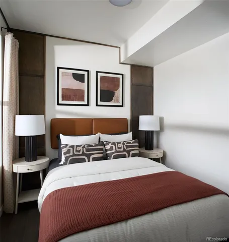 a bedroom with a bed and lamp