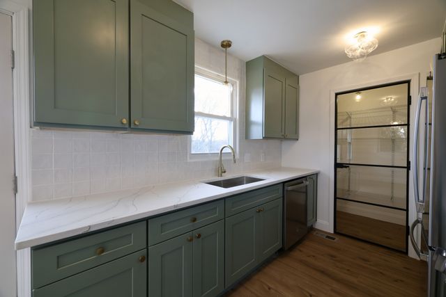a kitchen with a sink and cabinets
