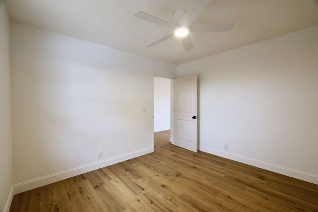 an empty room with wooden floor