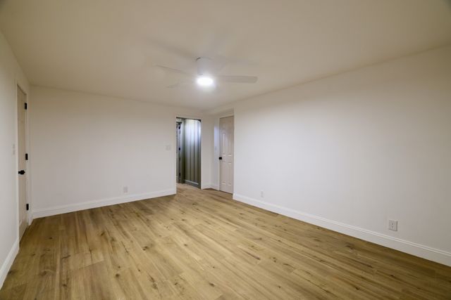 a view of an empty room and wooden floor