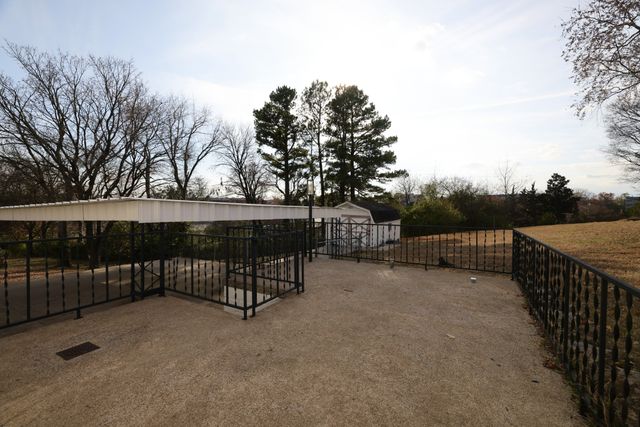 a view of a terrace with trees in the background