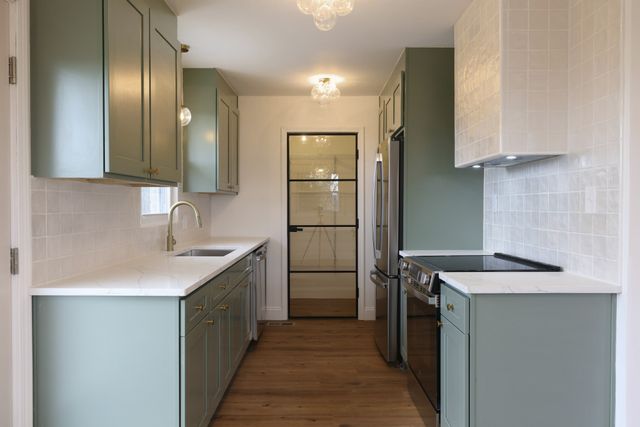 a kitchen with a sink refrigerator and microwave