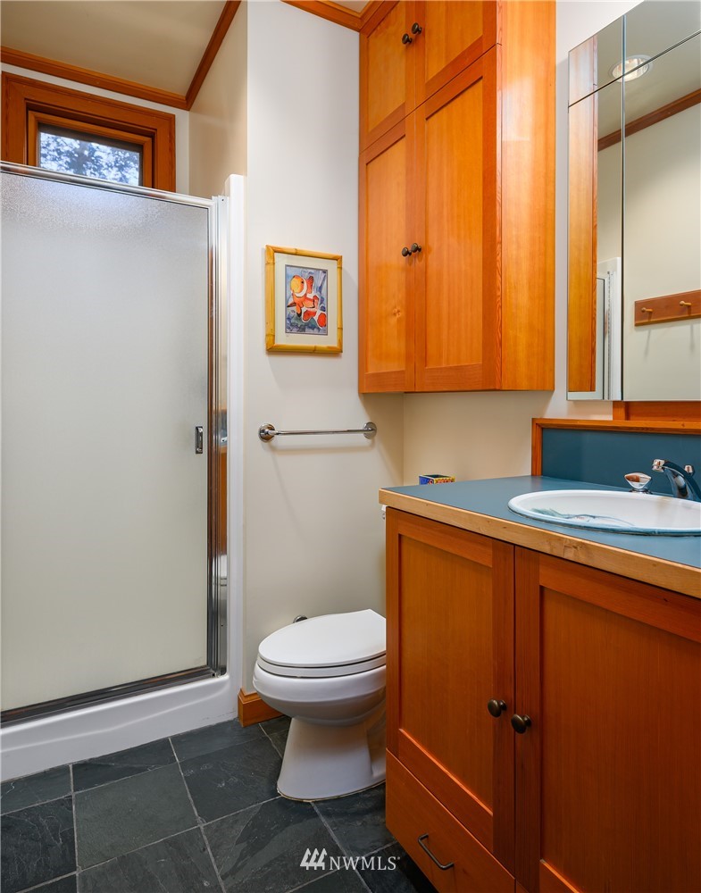 197 East Cove Road Decatur Island, WA 98221 - Photo 22 of 40 a bathroom with a toilet a sink and a window
