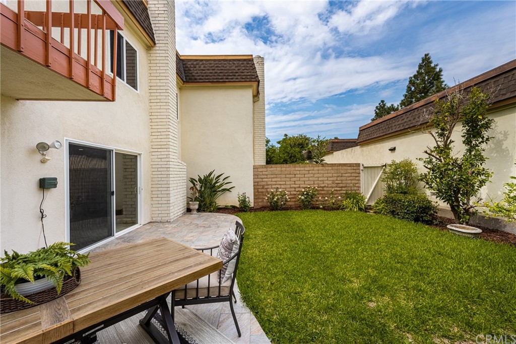 4091 Germainder Way Irvine, CA 92612 - Photo 15 of 47 a view of a patio with table and chairs and potted plants