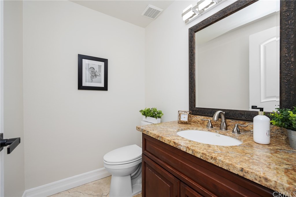 4091 Germainder Way Irvine, CA 92612 - Photo 17 of 47 a bathroom with a granite countertop sink and a mirror