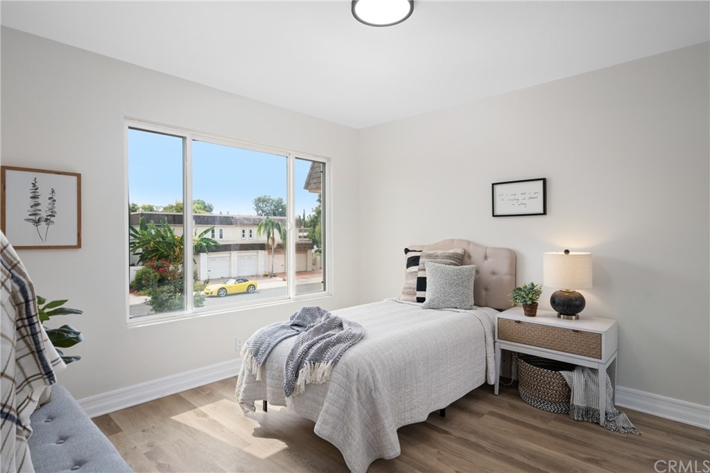 4091 Germainder Way Irvine, CA 92612 - Photo 27 of 47 a bedroom with a bed and wooden floor