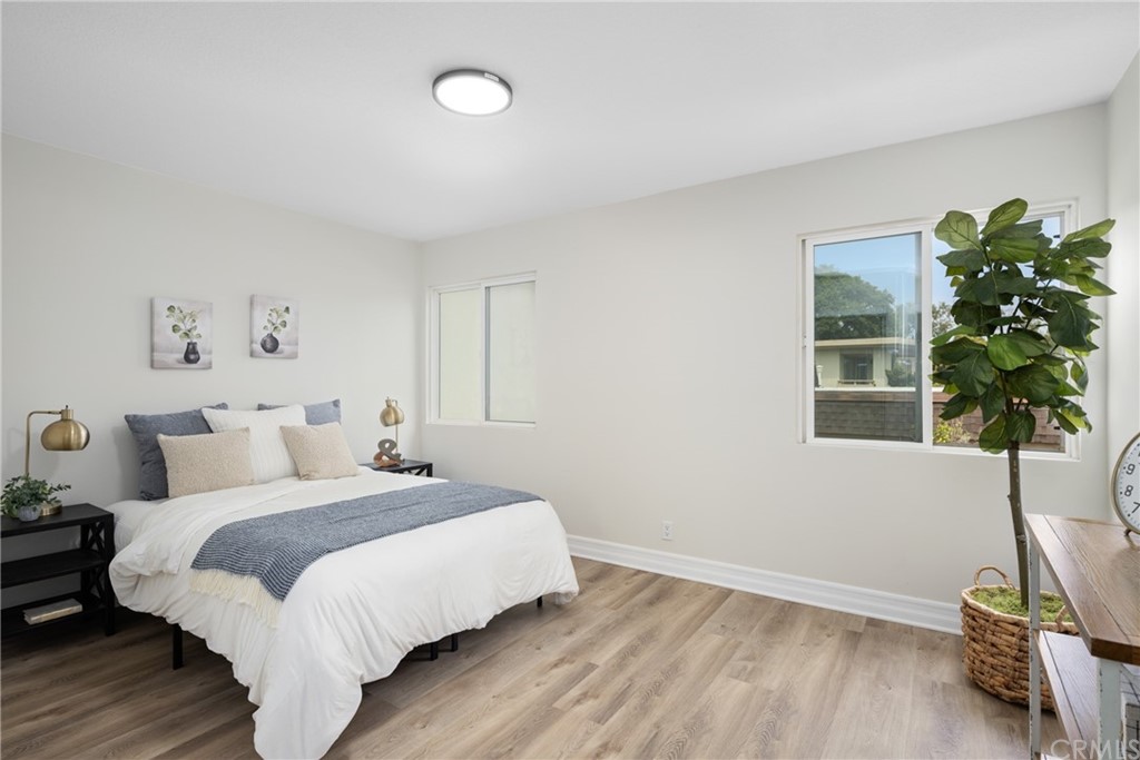 4091 Germainder Way Irvine, CA 92612 - Photo 30 of 47 a bedroom with a bed and a potted plant