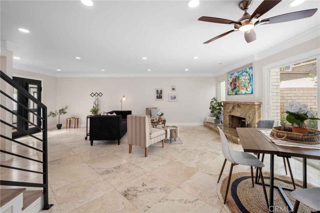 4091 Germainder Way Irvine, CA 92612 - Photo 7 of 47 a living room with furniture a fireplace and a chandelier