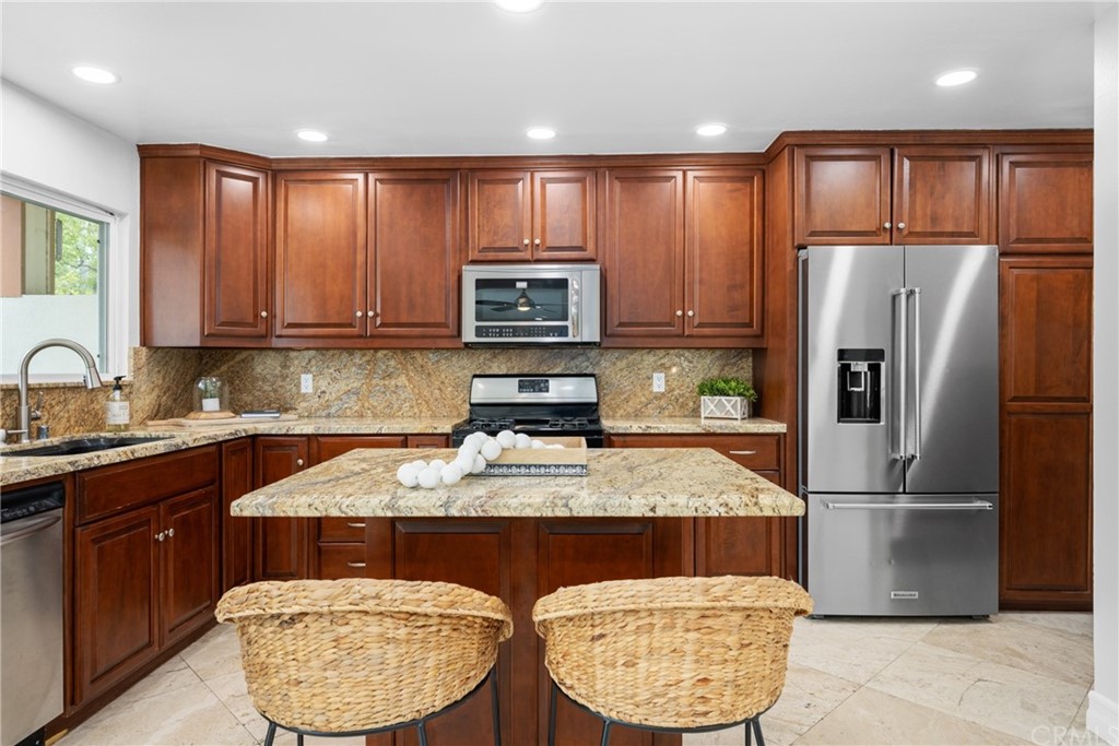 4091 Germainder Way Irvine, CA 92612 - Photo 9 of 47 a kitchen with a refrigerator a microwave a sink and cabinets
