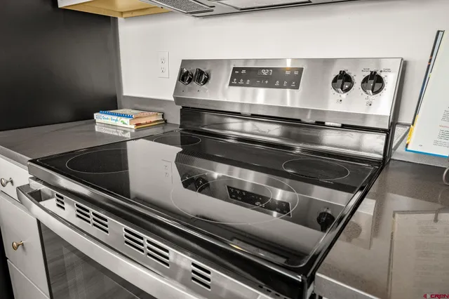 a kitchen with a sink a stove and chairs