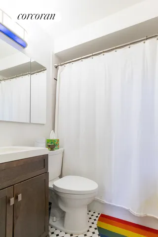 a kitchen with a refrigerator sink and cabinets