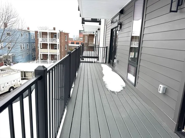 a view of balcony with wooden floor