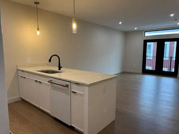 a kitchen with a sink and chandelier