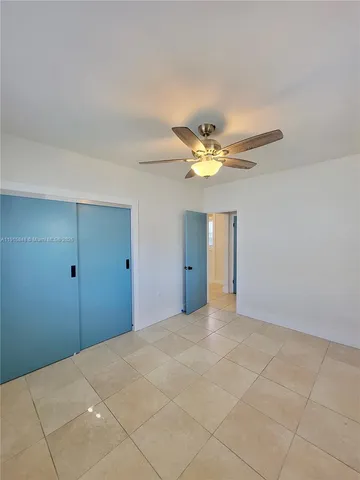 a view of a livingroom and a chandelier fan