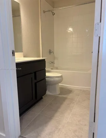 a bathroom with a bathtub sink vanity mirror and toilet